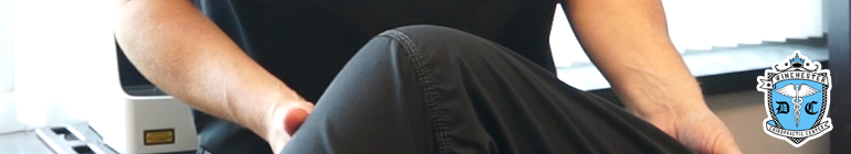 Close shot of a patient's knee is receiving chiropractic manipulation.