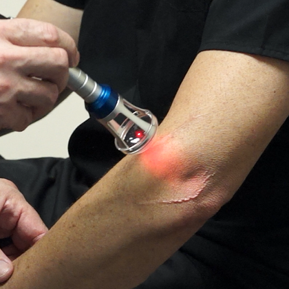 A closeup view of Doctor Kane administering the Class IV Laser Therapy to a patient.